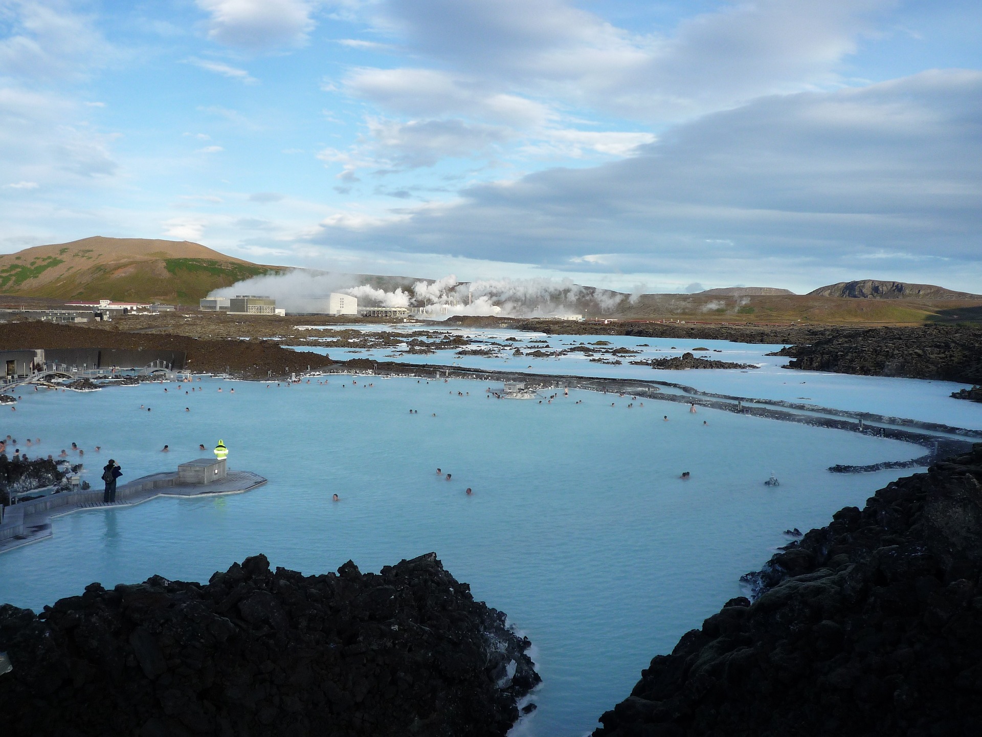 Wide scenic view of the blue lagoon pools as well as the volcanic landscape