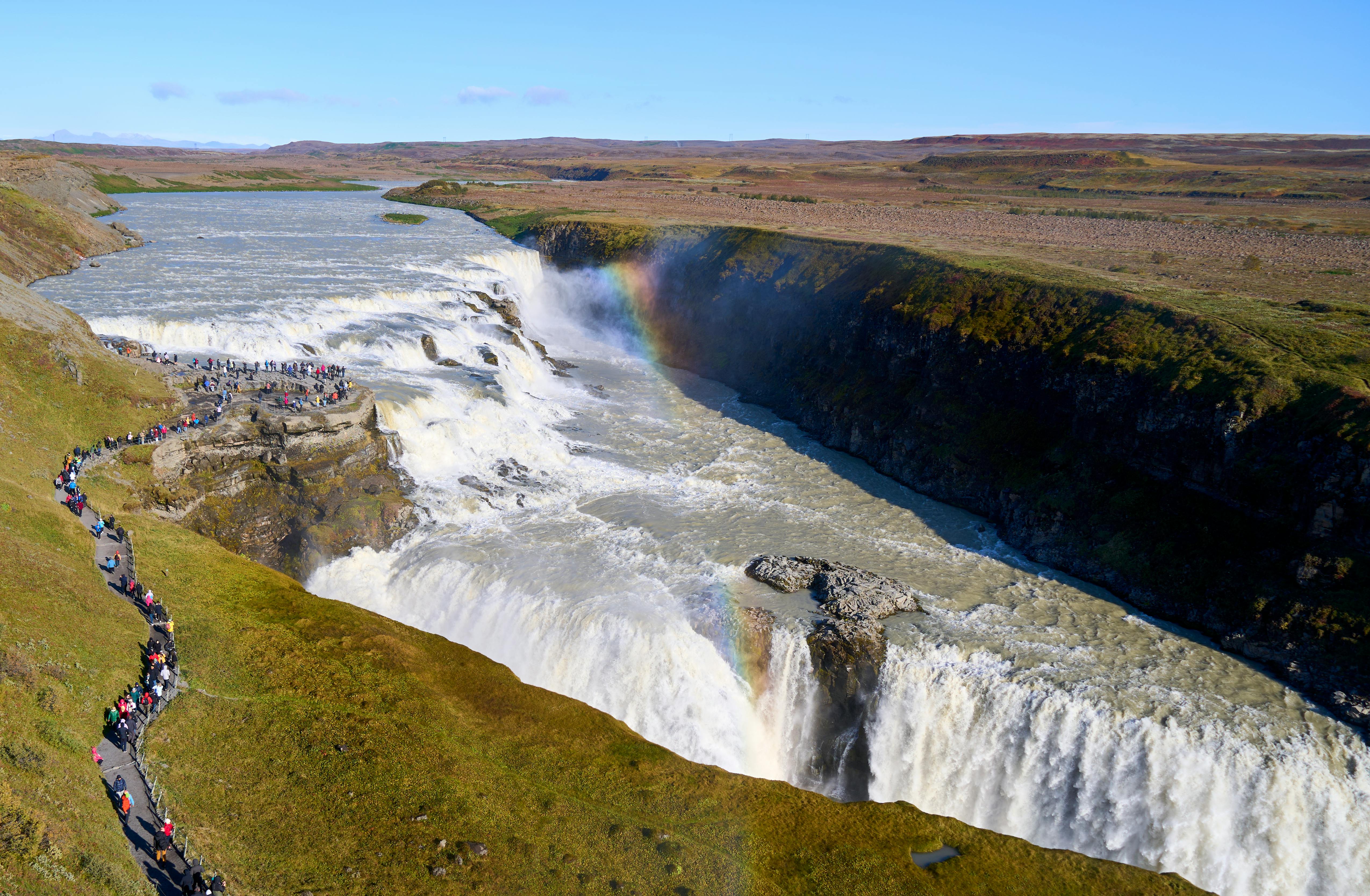 Areial view of the GullFoss Watefall with a slight rainbow appearing over it's canyon.